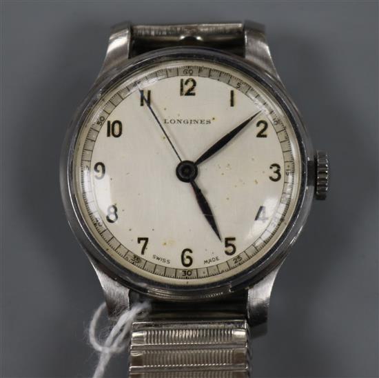 A gentlemans 1940s steel cased Longines manual wind wrist watch, on associated flexible strap.